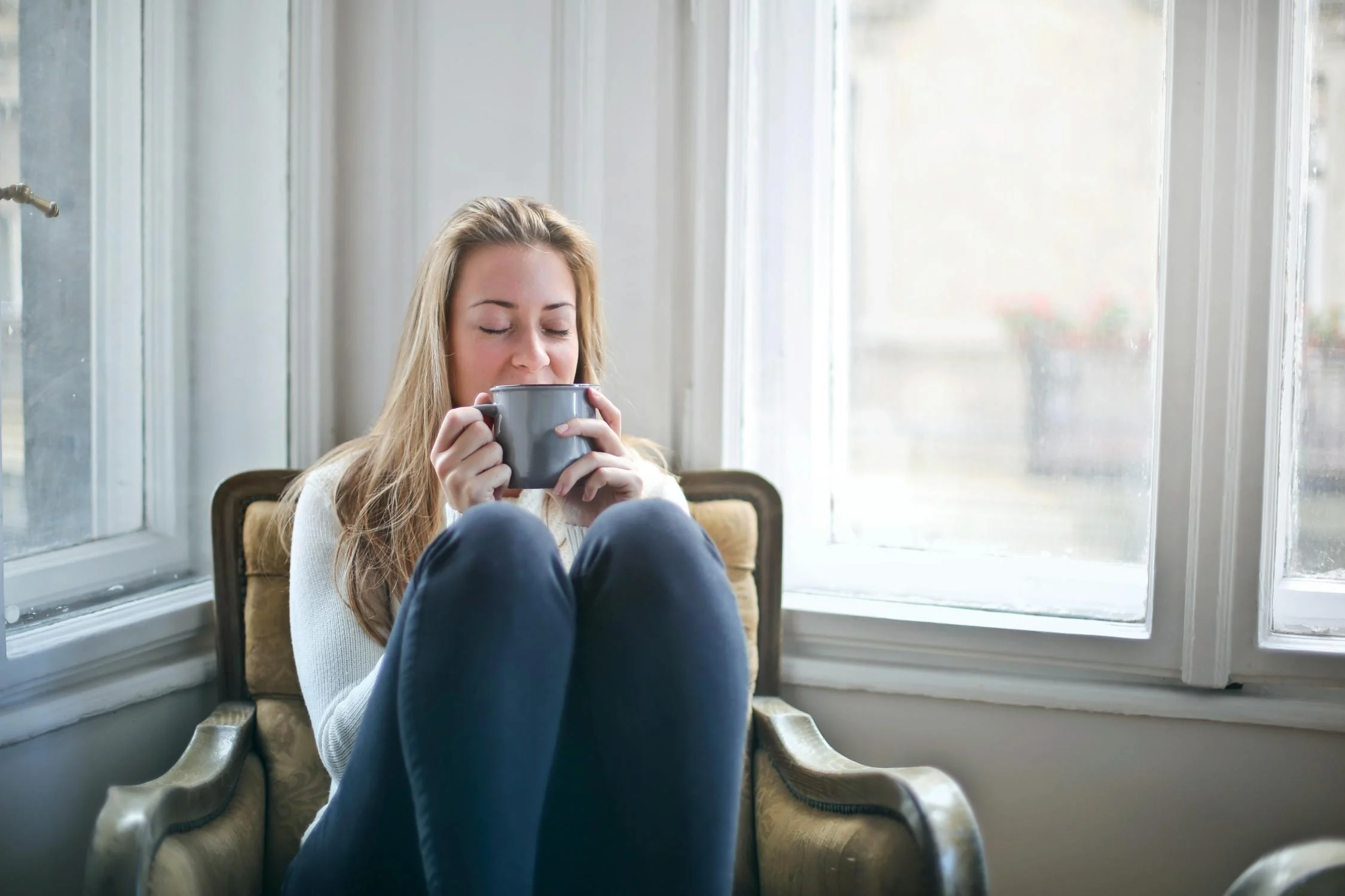 A satisfied woman drinking her coffee | Source: Pexels