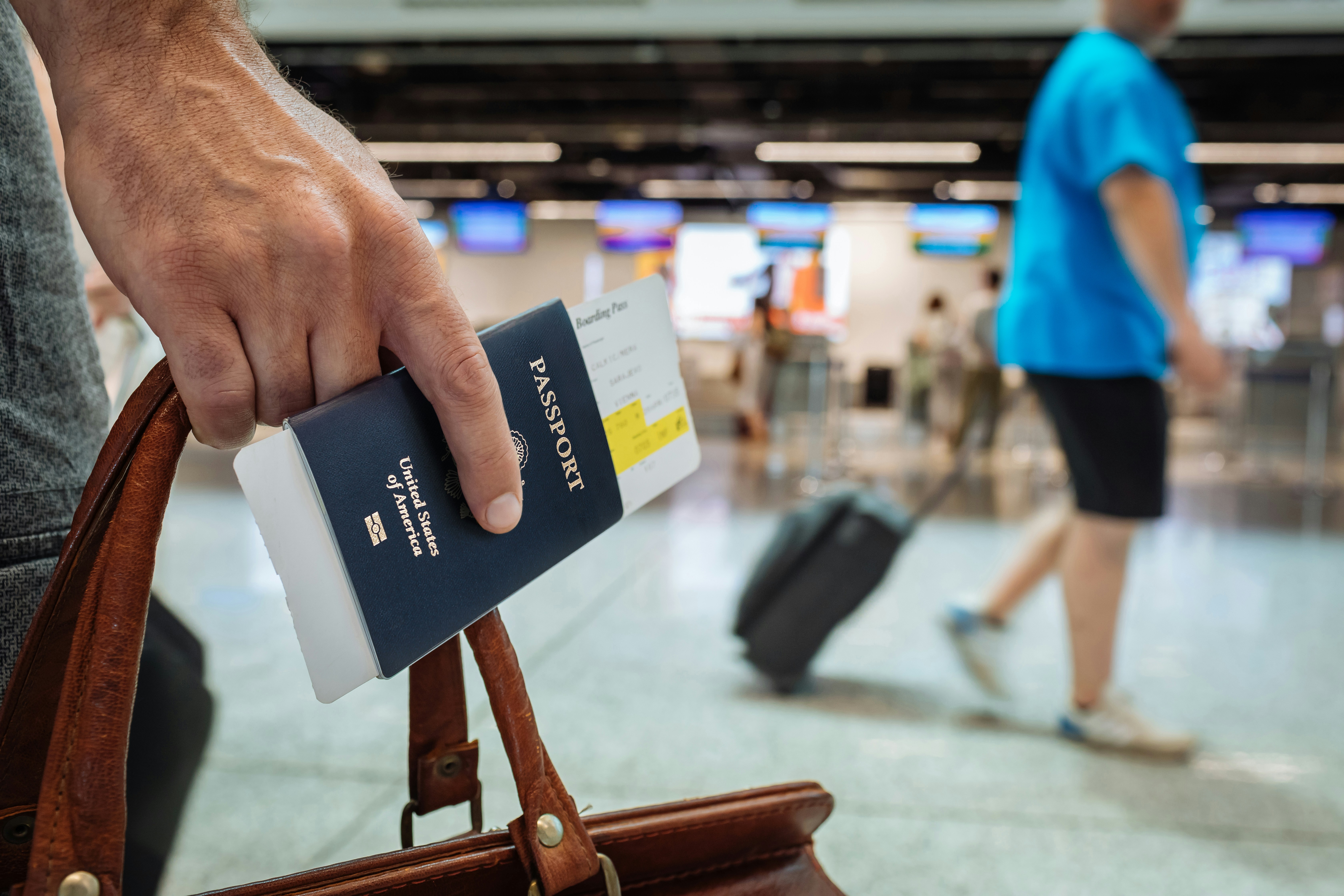 A person holding a passport at an airport | Source: Unsplash