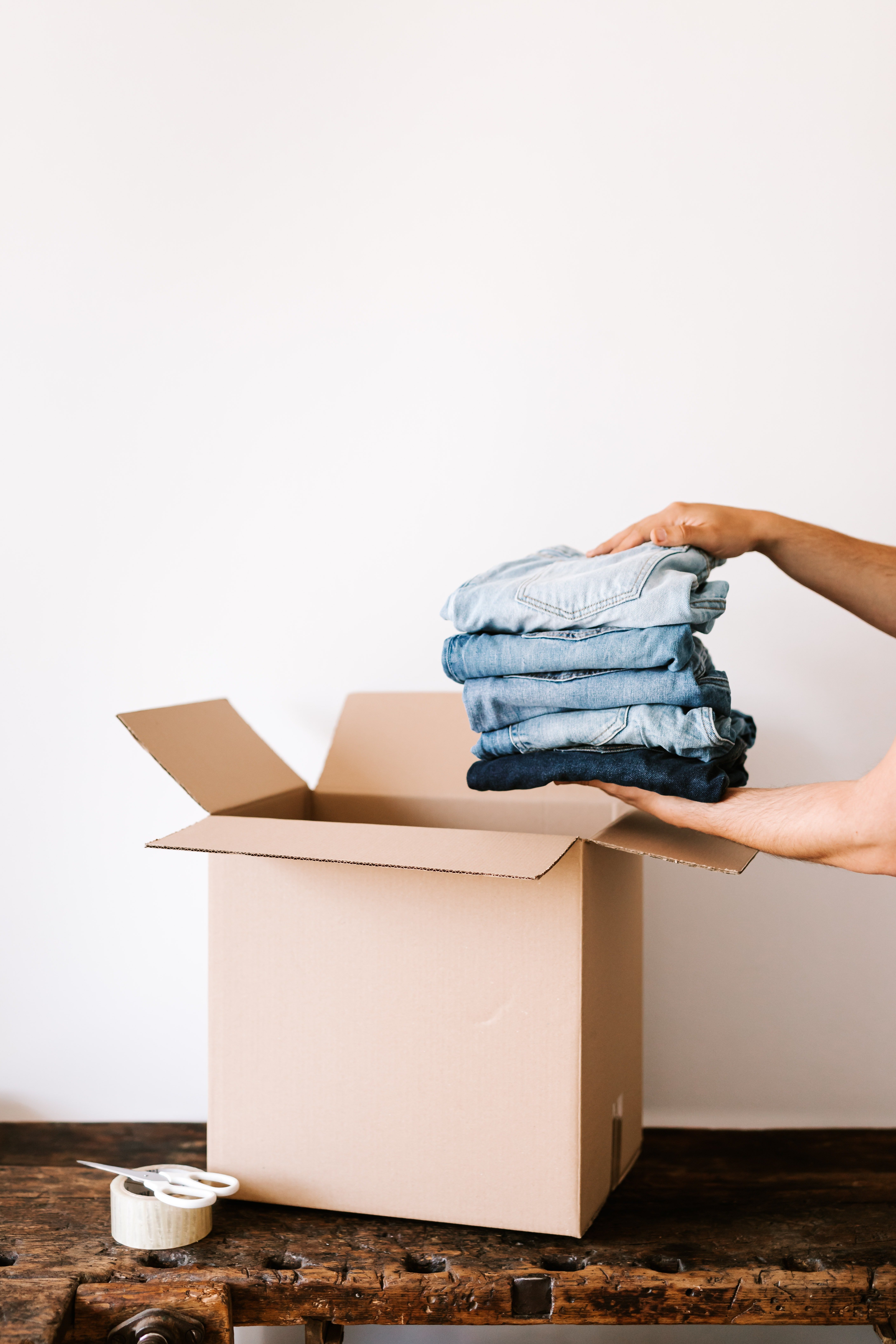 Putting clothes in a box | Source: Pexels