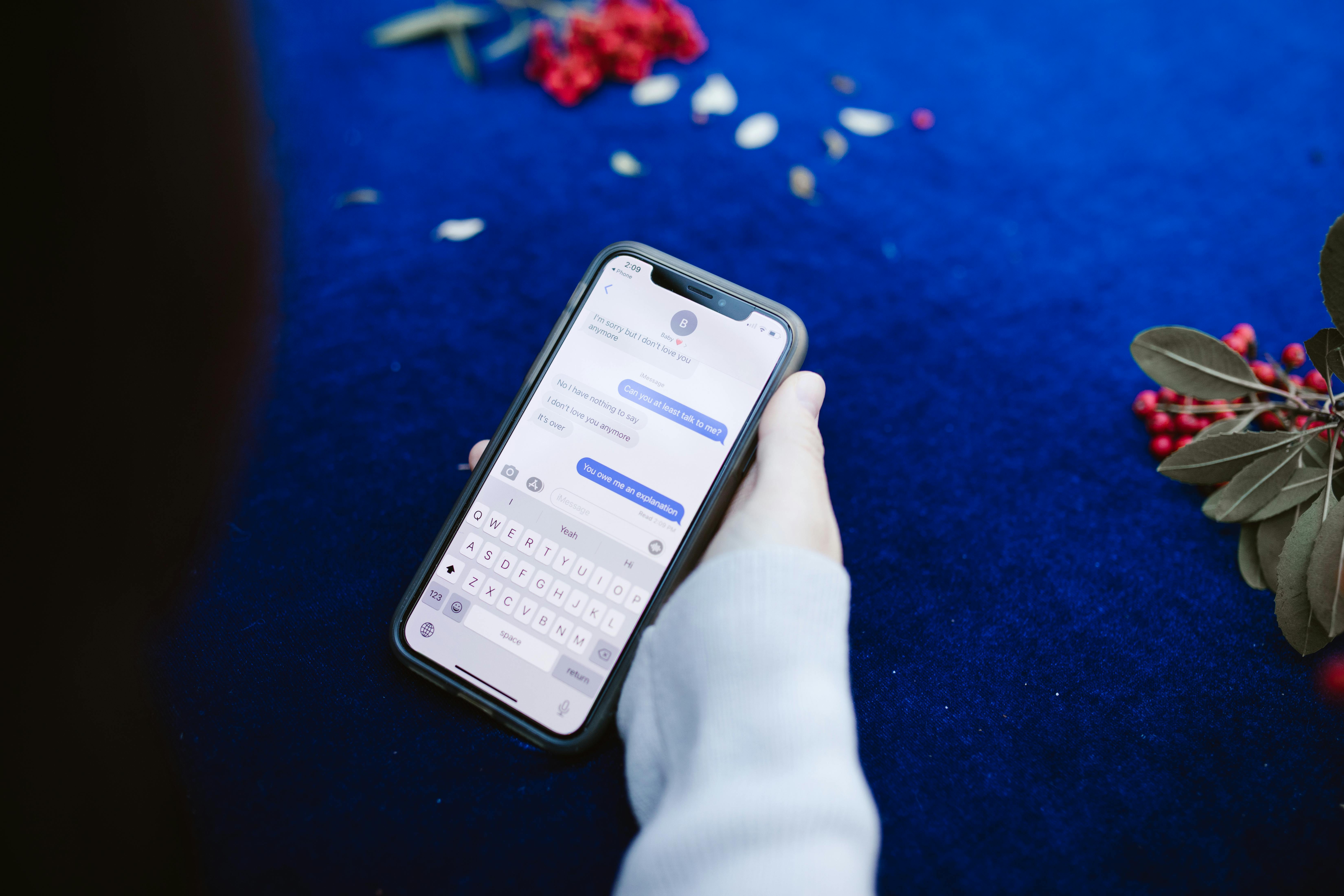 A person holding a cellphone open to text messages | Source: Pexels