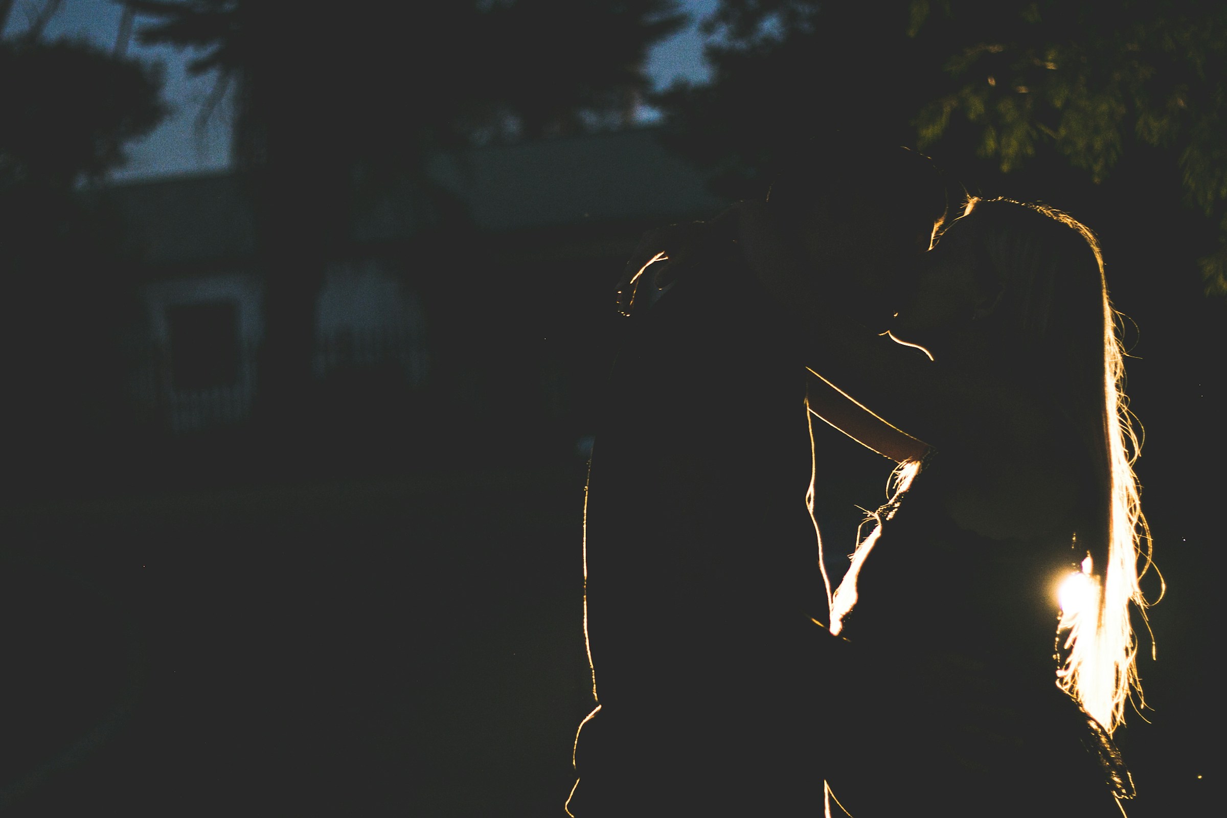 Night shot of a romantic couple locking lips | Source: Unsplash