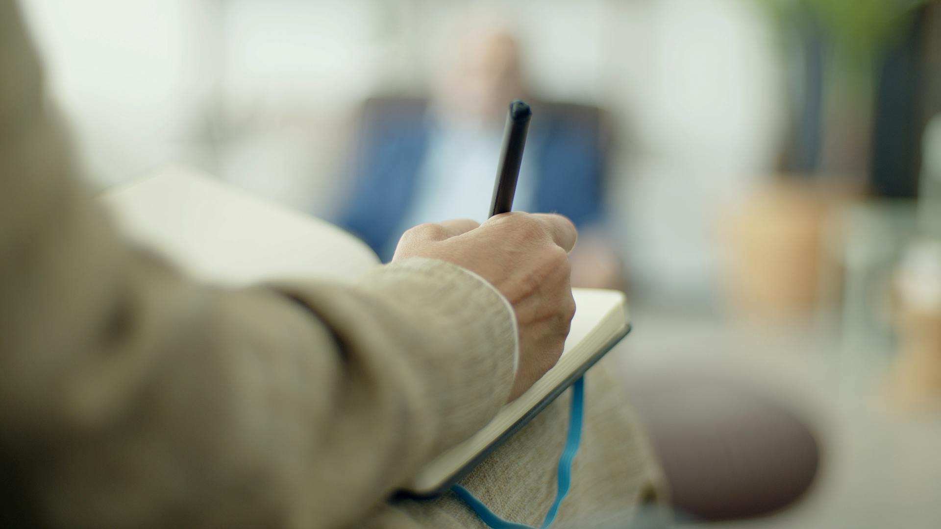 A woman writing in a notebook | Source: Pexels