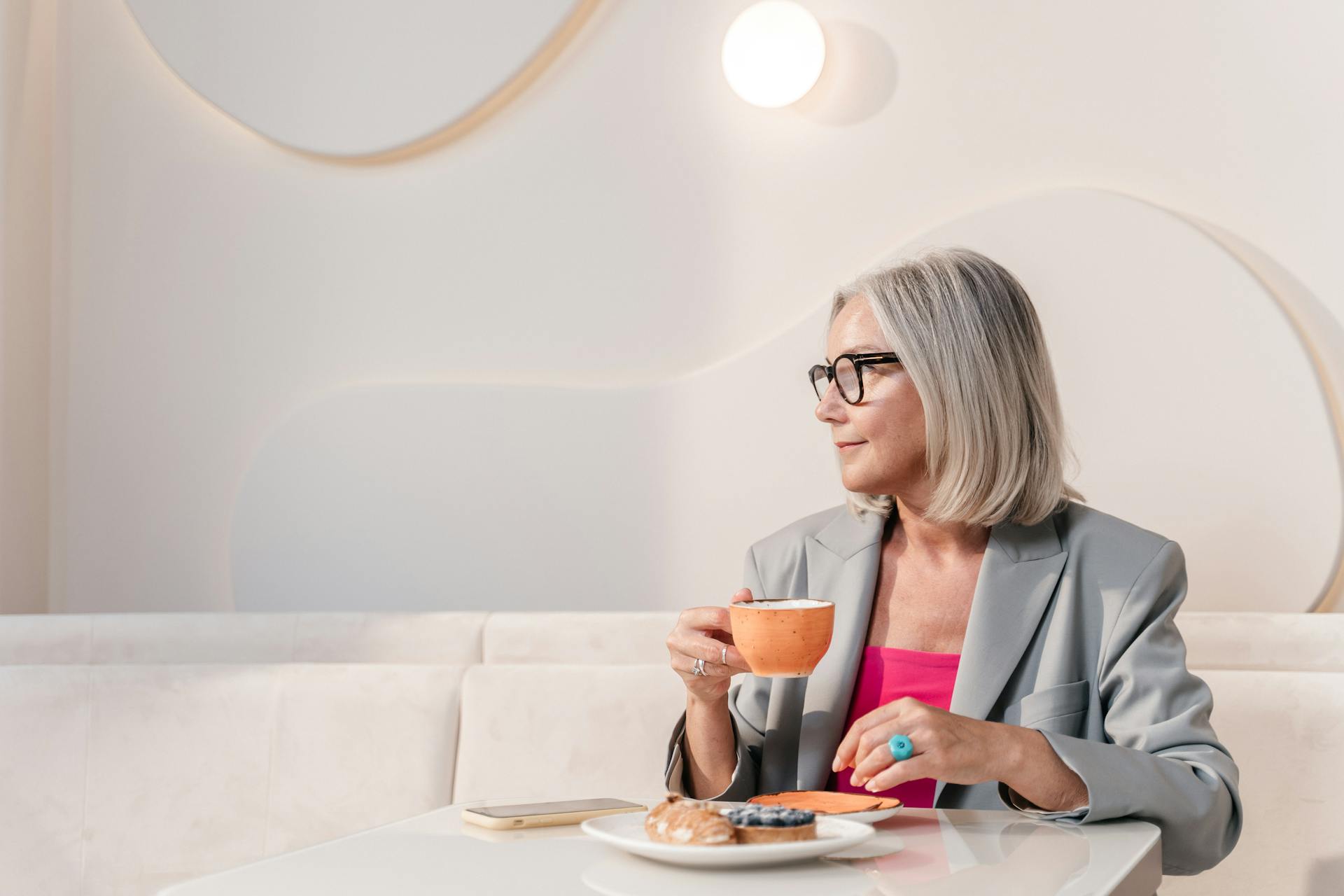 A woman glancing to one side in a coffee shop | Source: Pexels