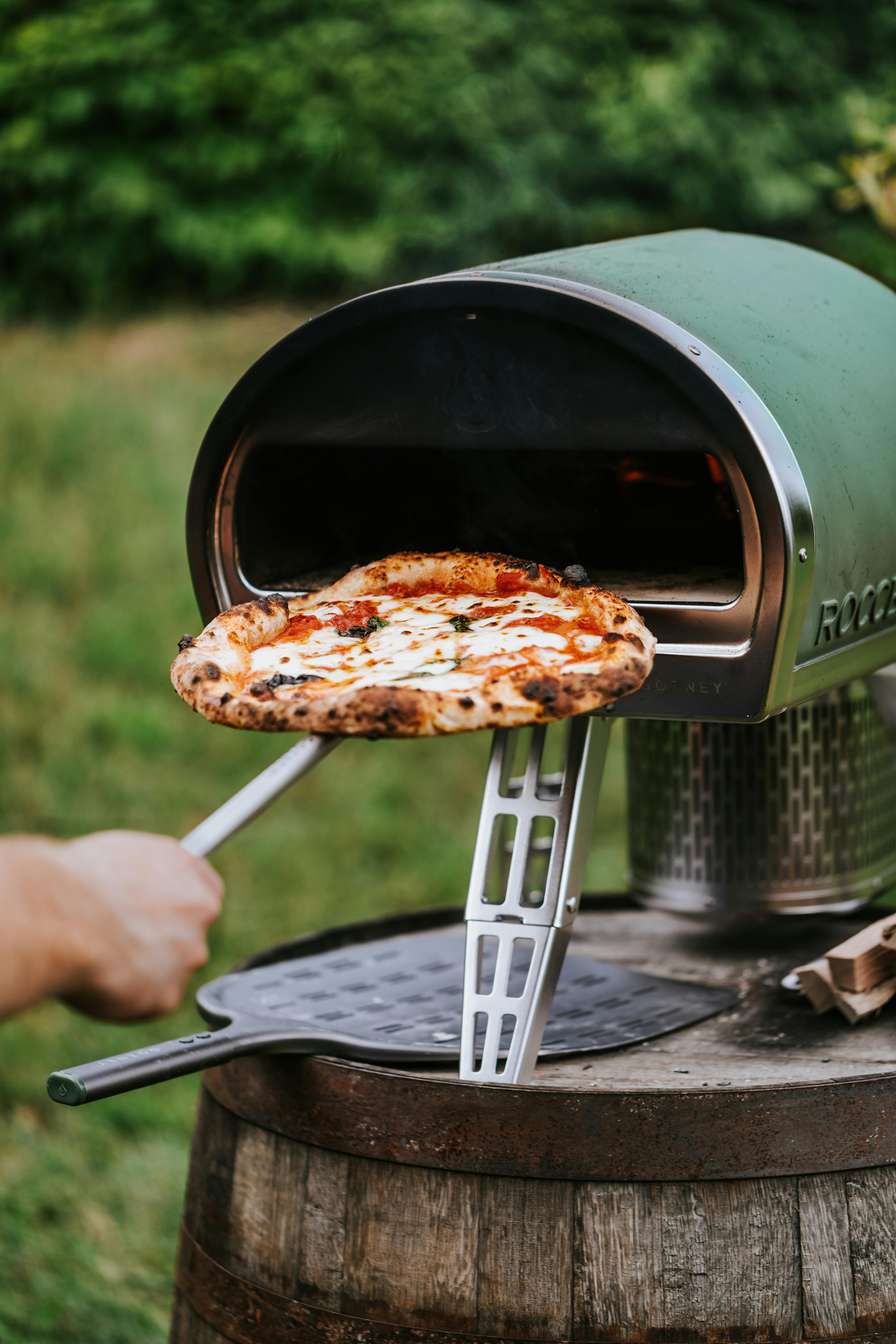 A person using a home pizza oven | Source: Pexels