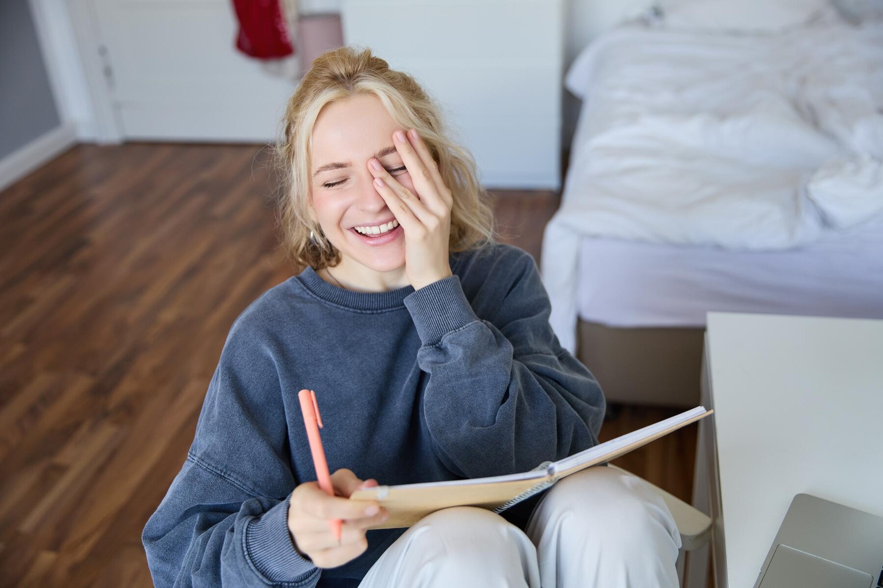 A laughing woman at home | Source: Freepik