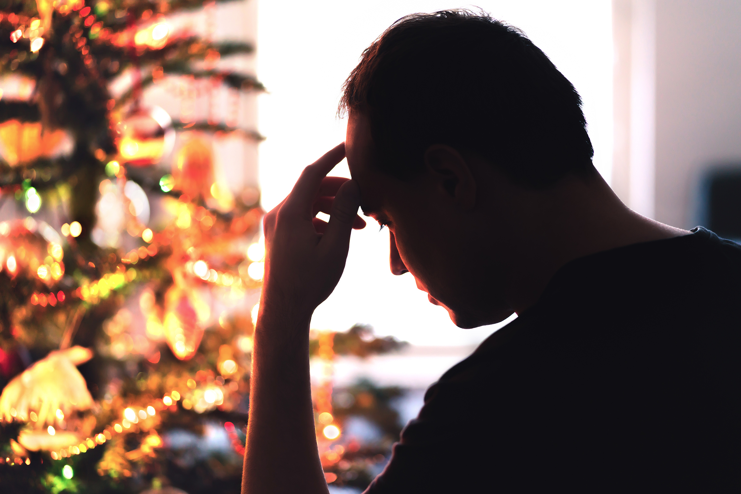 An upset man with his hand on his head | Source: Shutterstock