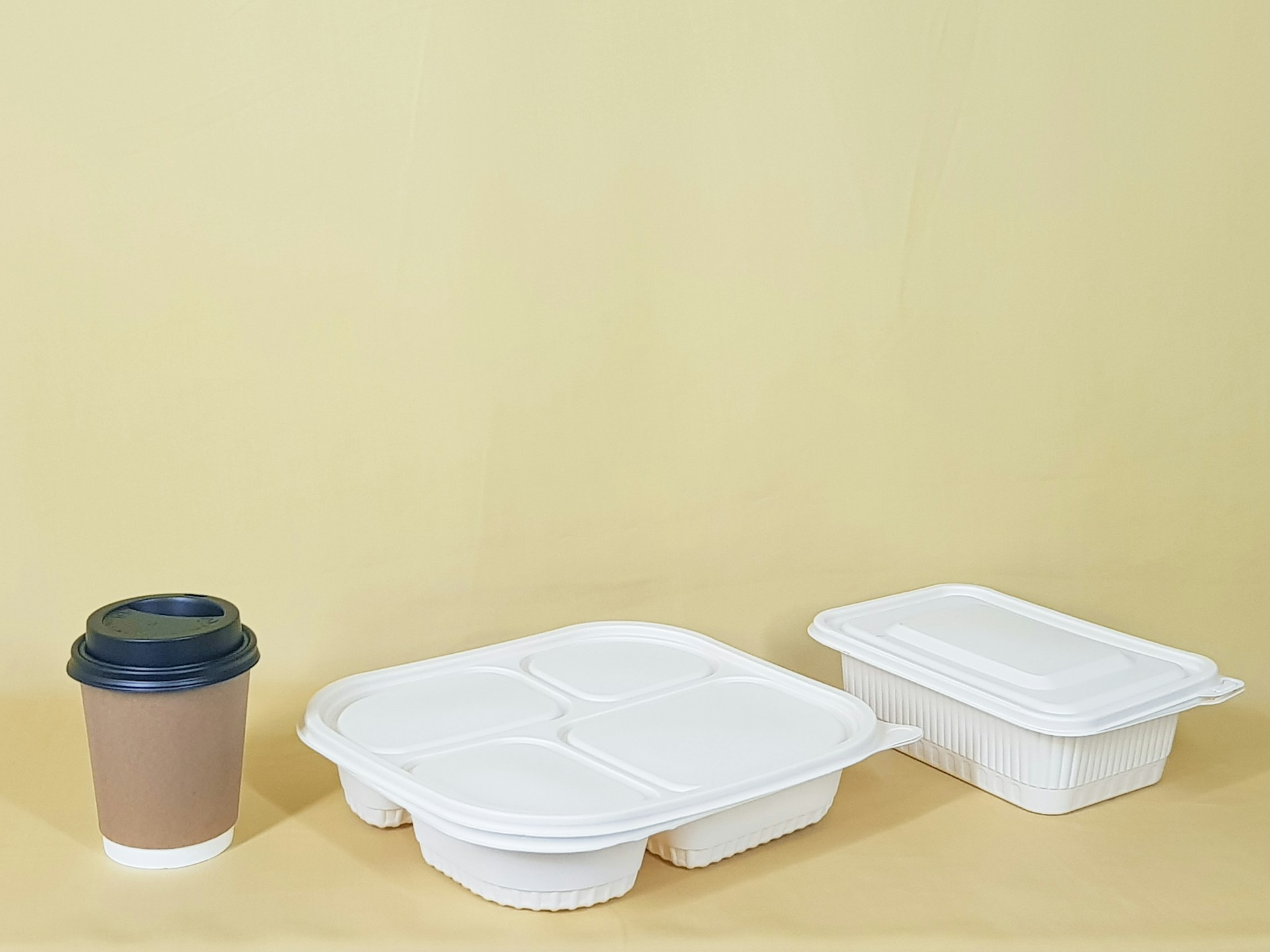 A cup beside two food containers | Source: Unsplash