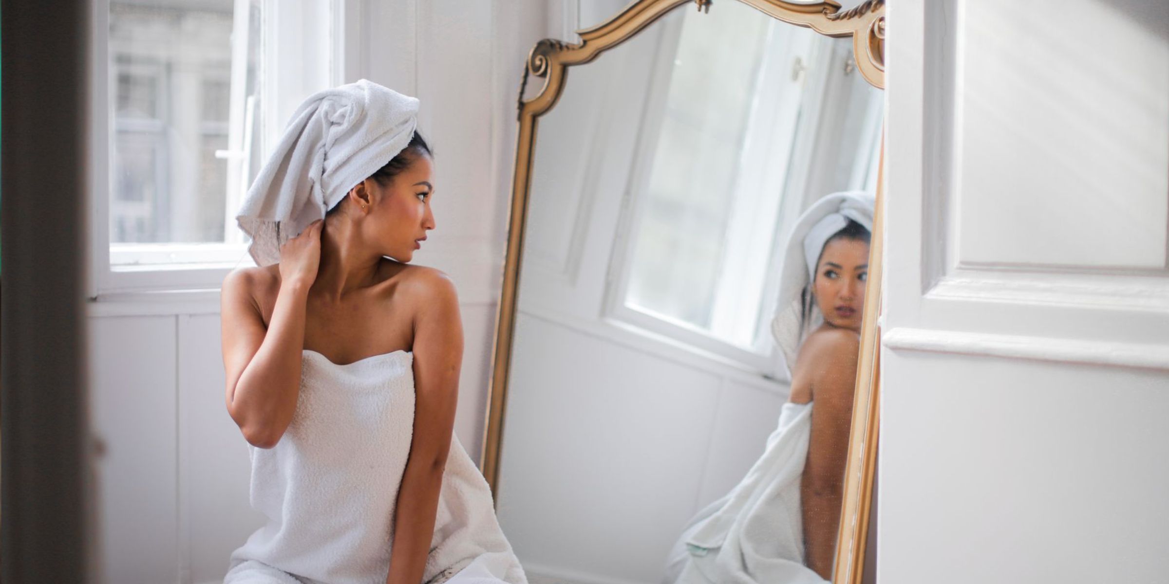 Woman sitting beside mirror after bathing | Source: Pexels