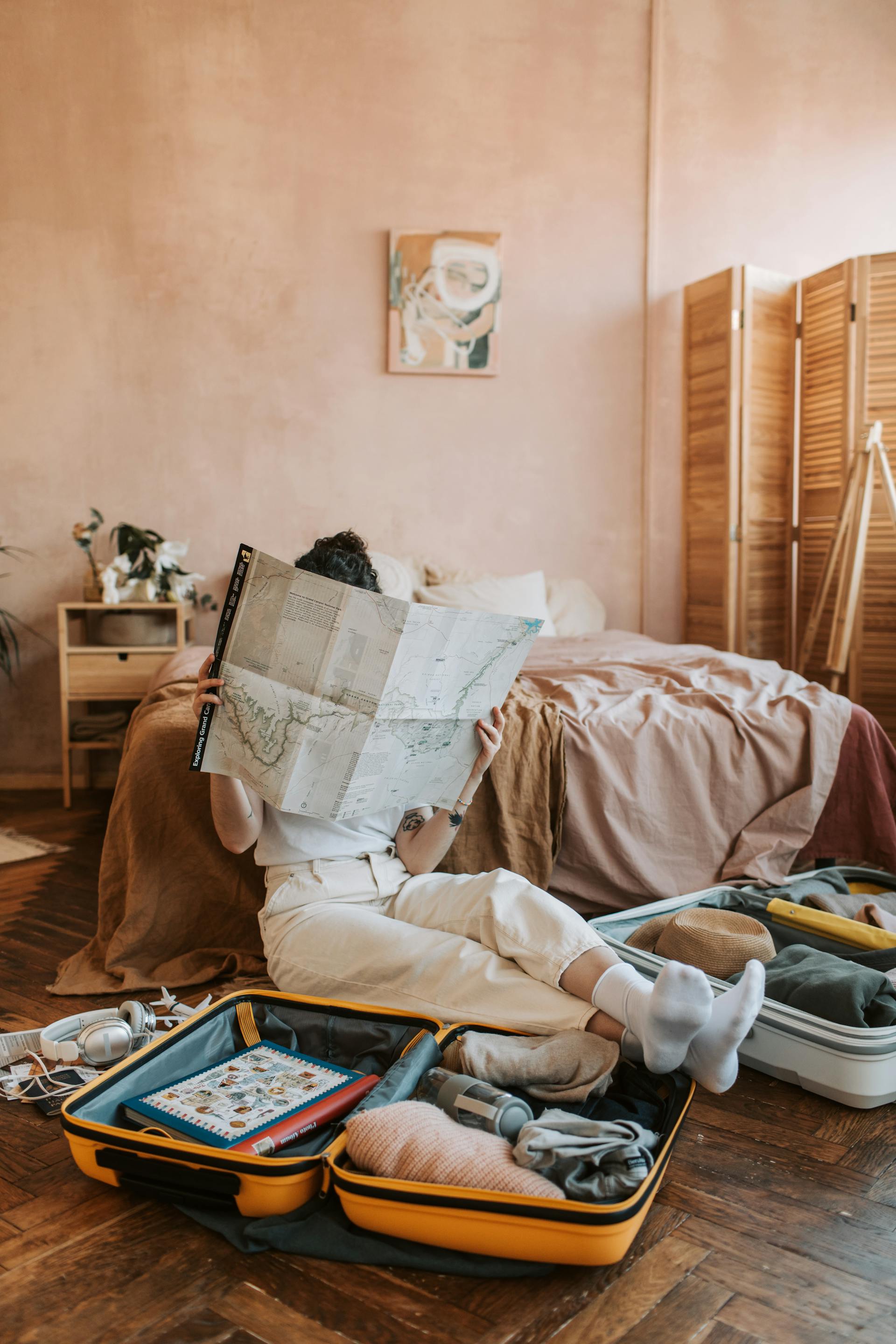 A woman looking at a map with luggage sitting around her | Source: Pexels