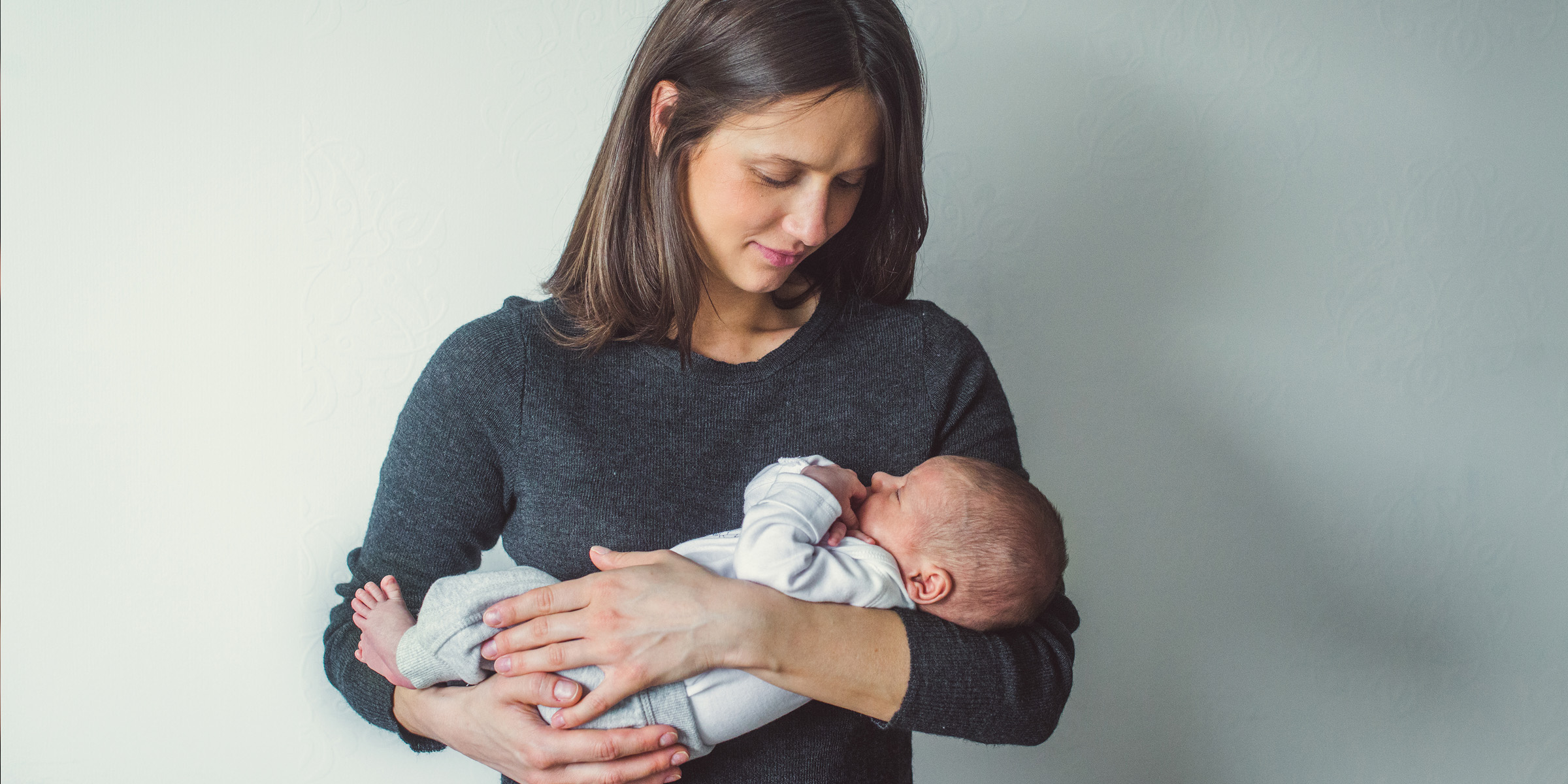 A woman holding a newborn baby | Source: Shutterstock