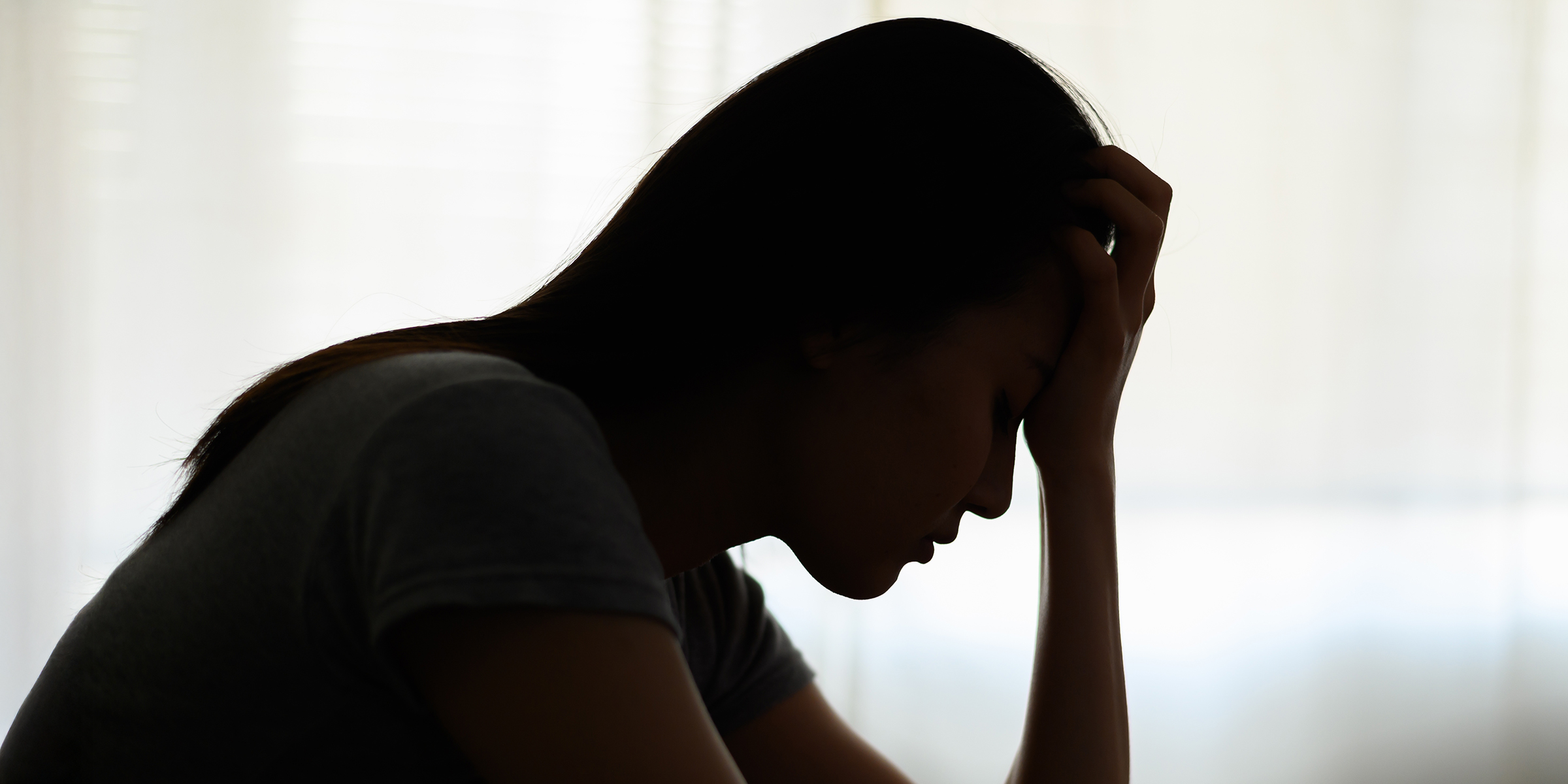 A silhouette of a distressed woman | Source: Shutterstock