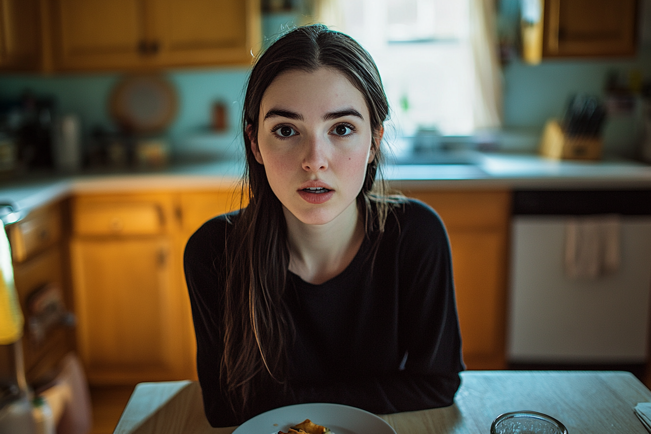 A shocked woman sitting at a dinner table | Source: Midjourney