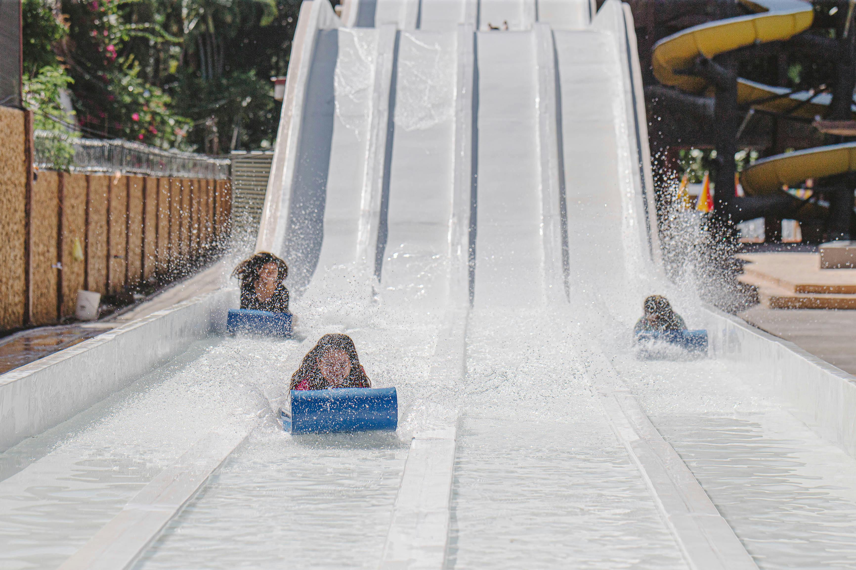 People going down a water slide | Source: Pexels