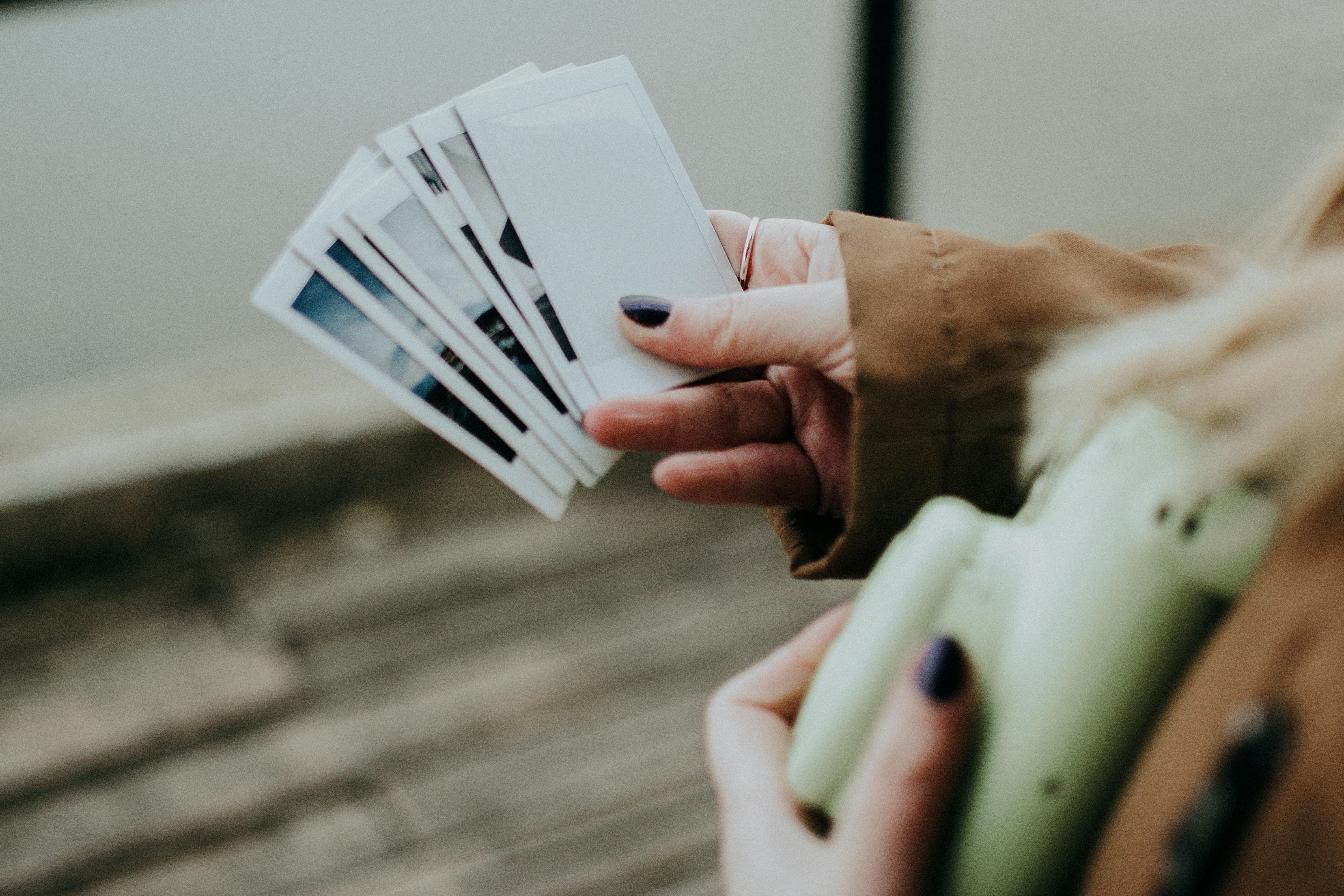 A person holding photographs | Source: Pexels