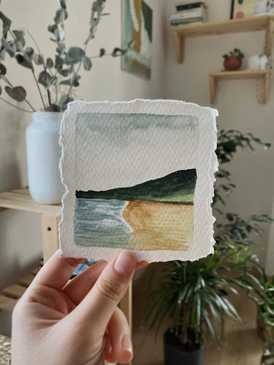 A woman holding a small painting | Source: Pexels