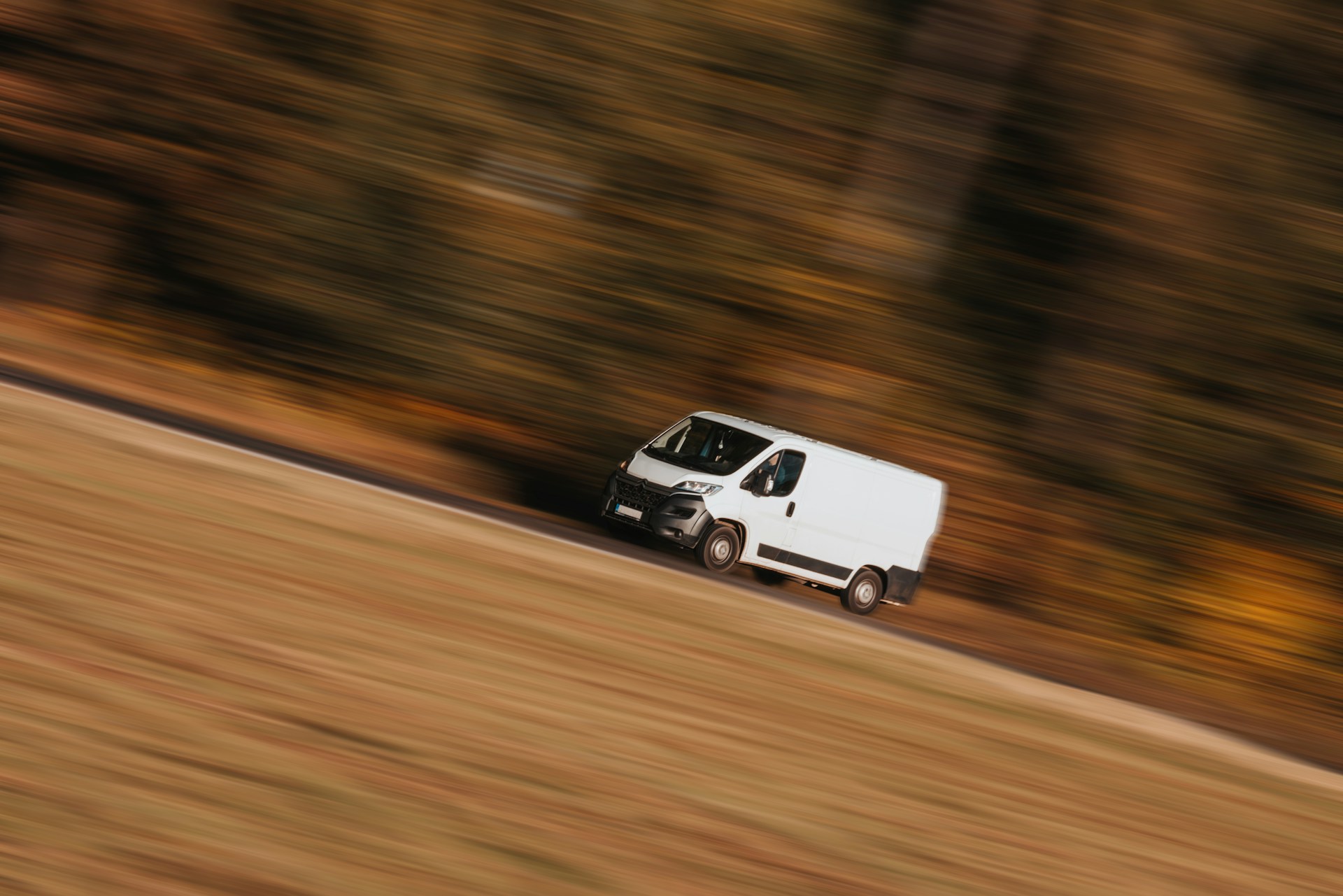 A delivery van speeding down a road | Source: Unsplash