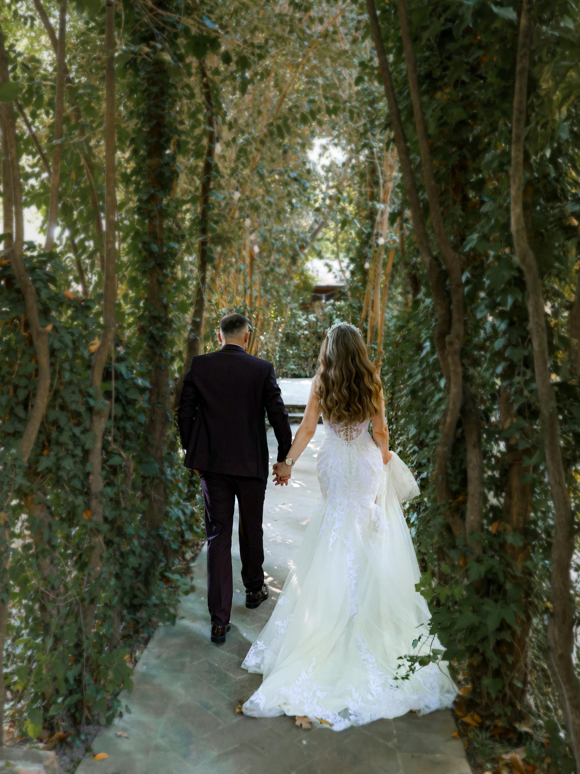 A back-view of a couple walking down the aisle | Source: Pexels