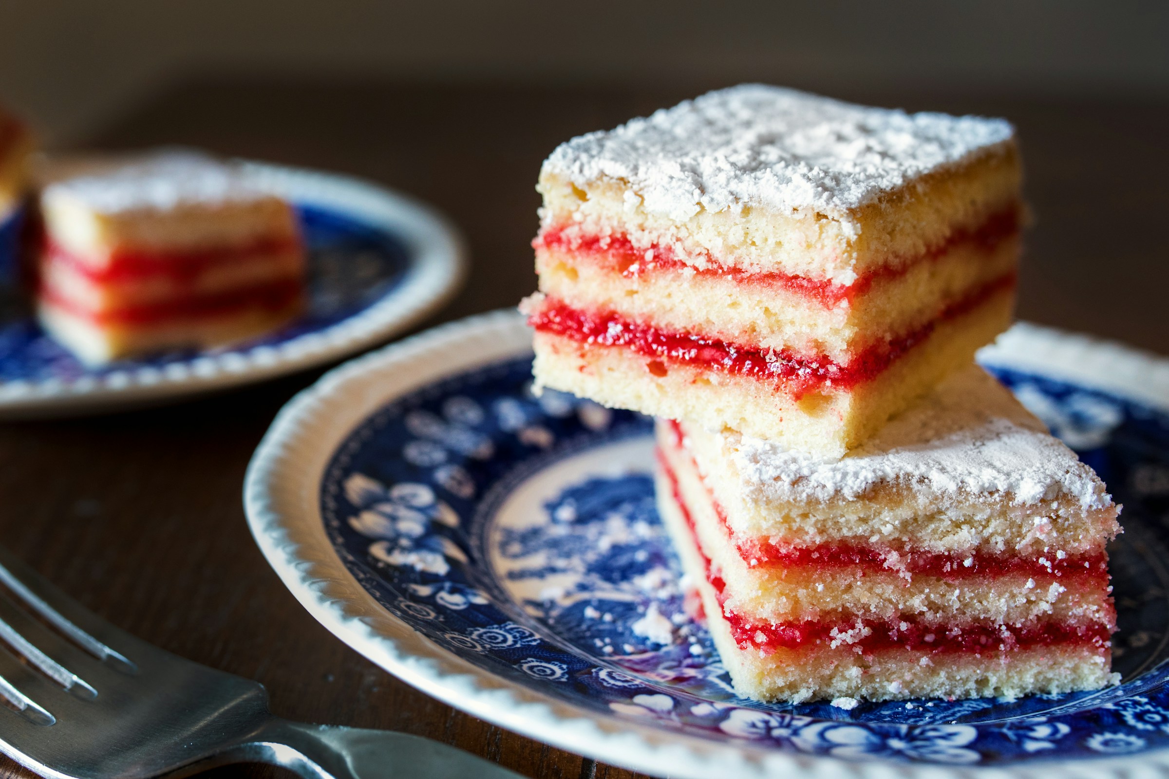 Layered strawberry sheet cake slices on two plates | Source: Unsplash