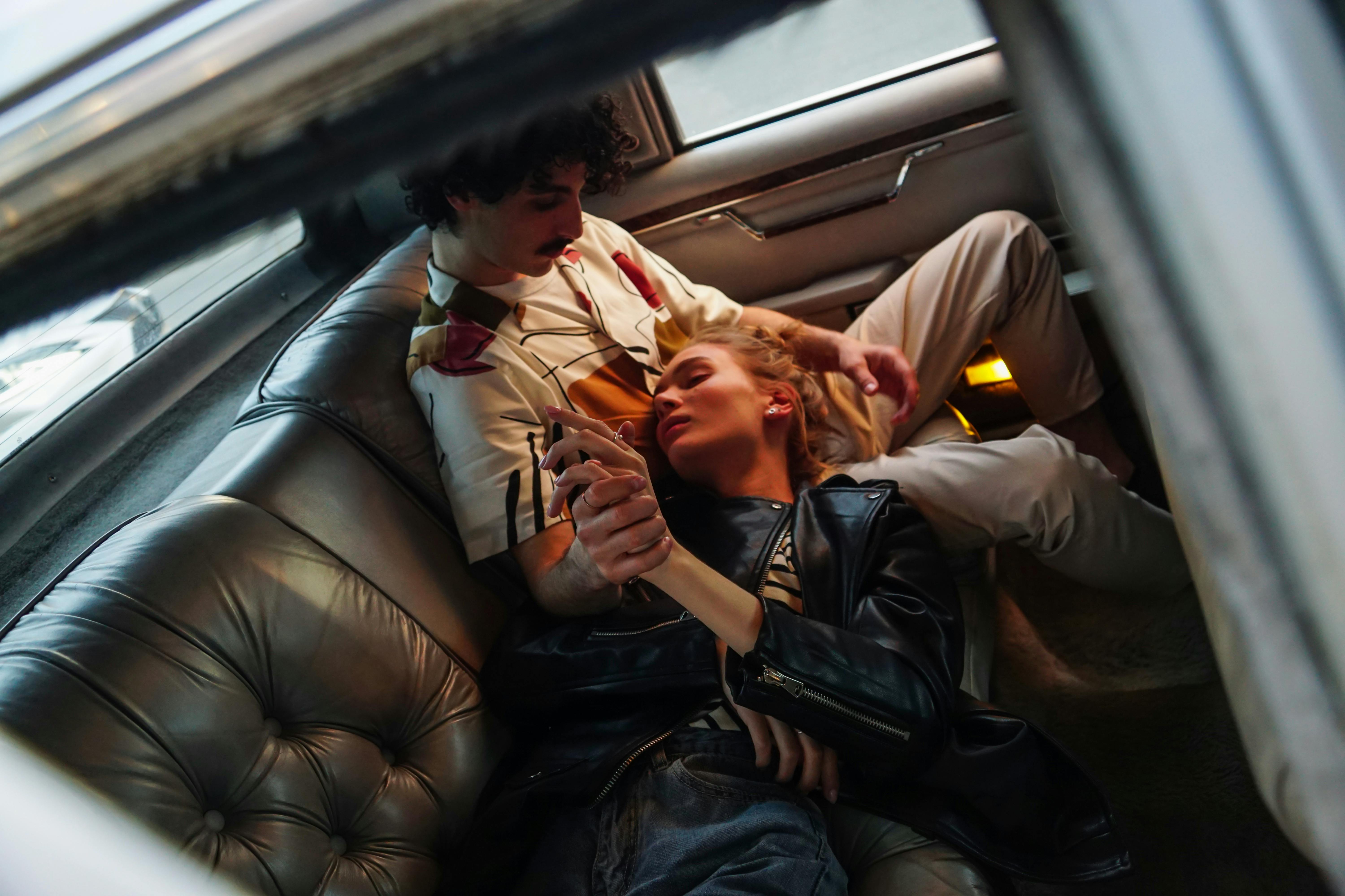 Woman lying on the lap of a man inside a car | Source: Pexels